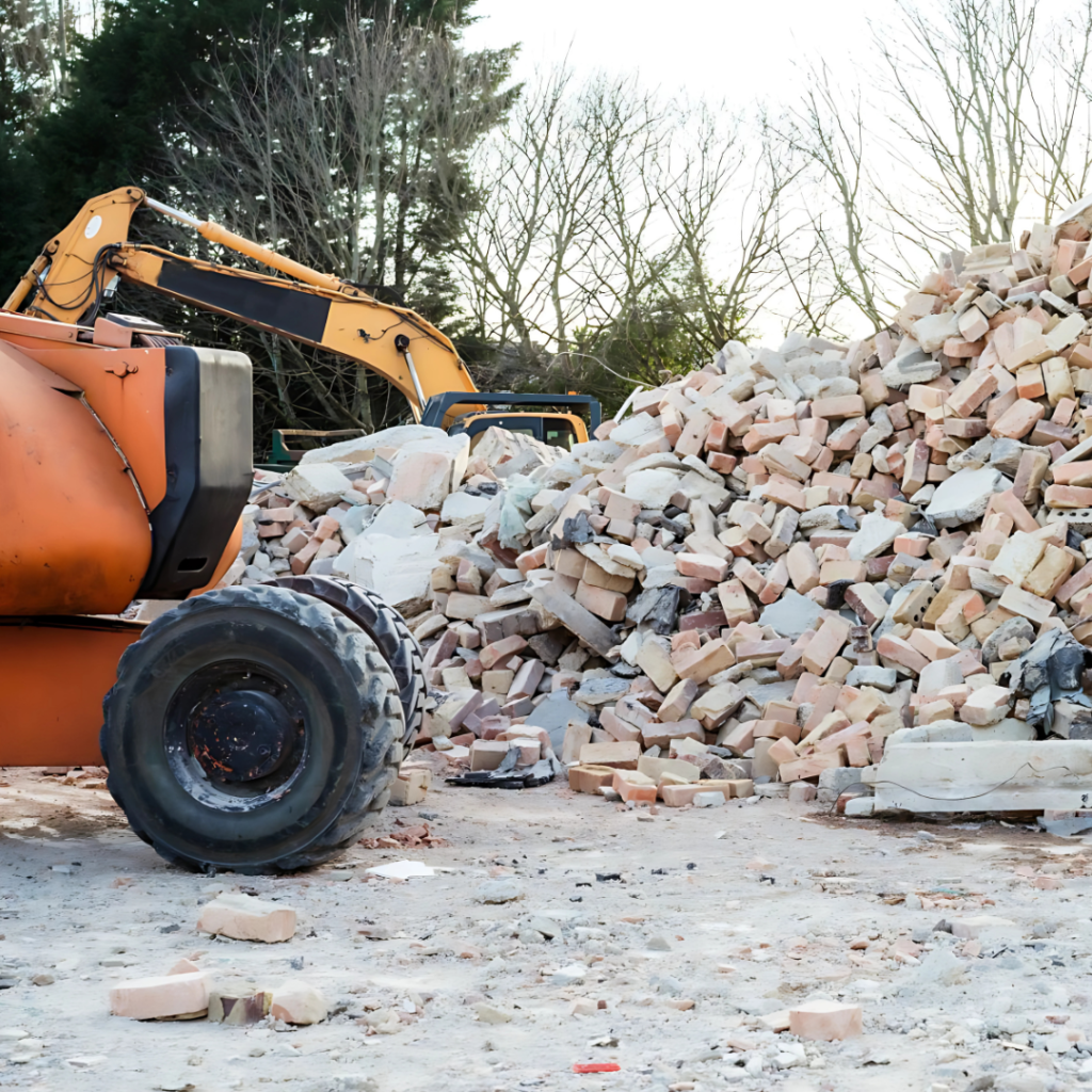 Experienced land work team clearing mixed debris from access route with professional equipment